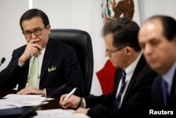 FILE - Mexico's Economy Minister Ildefonso Guajardo listens during the presentation of Mexico's negotiating team for the renewal of the North American Free Trade Agreement (NAFTA) in Mexico City, Mexico, Aug. 2, 2017.