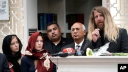 Jason Cogburn, right, speaks as his wife, Joleen, left, and daughter, Jaelyn, far left, listen during a funeral for Pakistani exchange student Sabika Sheikh, who was killed in the Santa Fe High School shooting.