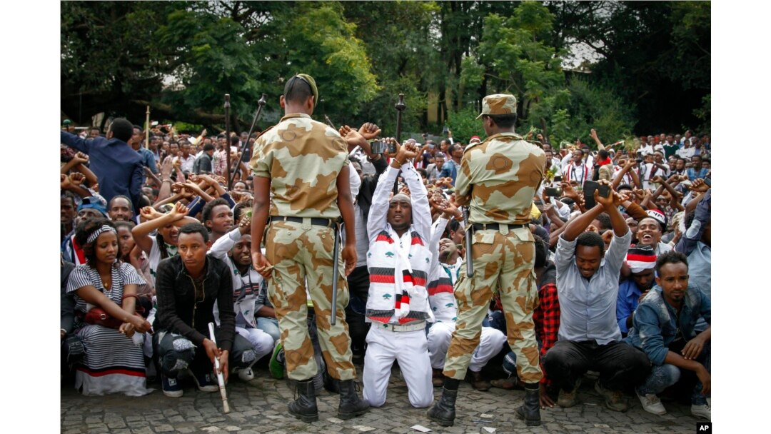 FILE - Ethiopian soldiers try to stop protesters in Bishoftu, in the Oromia region of Ethiopia.