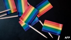 Miniature rainbow flags are offered during the UN GLOBE event celebrating for the first time on the International Day against Homophobia and Transphobia, May 17, 2018, at United Nations Office in Nairobi, Kenya.