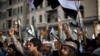 Shi'ite Houthi rebels hold up their weapons at a rally against Saudi-led airstrikes against them, in Sana'a, Yemen, April 10, 2015. 