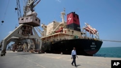 FILE - A cargo ship is docked at the Red Sea port city, of Hodeida, Yemen, Sept. 29, 2018.