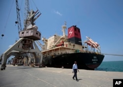 FILE - A cargo ship is docked at the Red Sea port city, of Hodeida, Yemen, Sept. 29, 2018.