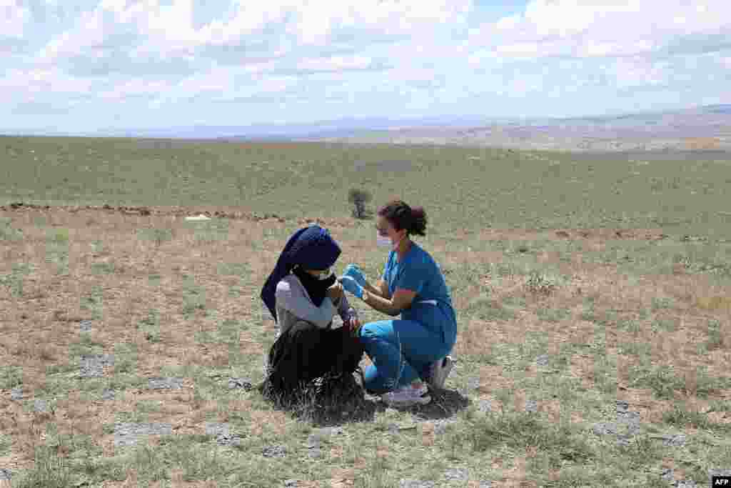 A health worker vaccinates a farm worker in the village of Oguzlar, a hundred of kilometers away from Ankara, Turkey.