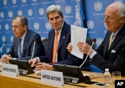 U.N. Special Envoy for Syria Staffan de Mistura, right, shows a copy of a Security Council resolution concerning Syria, during a press conference with Russian Foreign Minister Sergei Lavrov, left, and U.S. Secretary of State John Kerry at U.N. headquarte