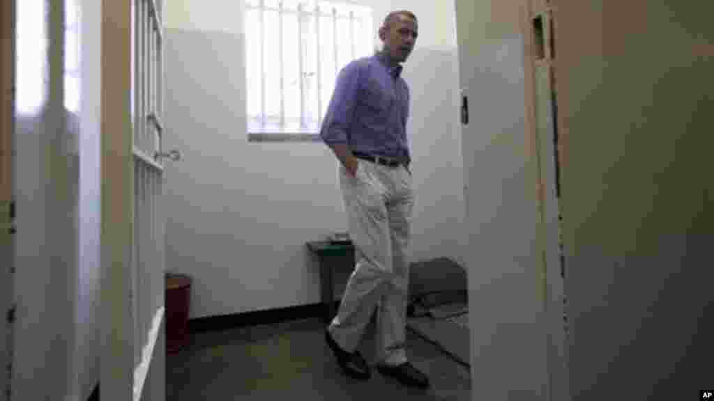 U.S. President Barack Obama looks out from Section B, prison cell No. 5, on Robben Island, South Africa.