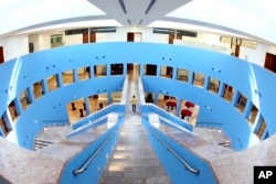 FILE - A man walks along a pathway in the Texas A&M University campus at Education City in Doha, Qatar, in this 2011 photo.