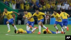 Brazil's players react as Neymar scores the decisive penalty kick during the final match of the men's Olympic soccer tournament at Maracana Stadium in Rio de Janeiro, Brazil, Aug. 20, 2016.