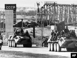 FILE - Soviet combat vehicles are seen crossing Soviet-Afghan border as Soviet troops return home from Afghanistan. (AP Photo)