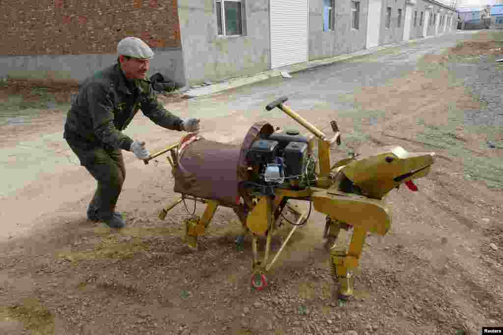 A man presents a self-made robot that local media reported is able to carry a person, in Heihe, Heilongjiang province, China.