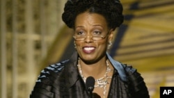 Dianne Reeves accepts her award for best jazz vocal album for "A Little Moonlight" during the 46th Annual Grammy Awards, Sunday, Feb. 8, 2004, in Los Angeles.