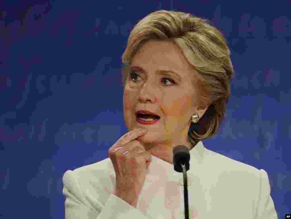 Democratic presidential nominee Hillary Clinton listens to Republican presidential nominee Donald Trump during the third presidential debate at UNLV in Las Vegas, Oct. 19, 2016.