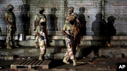 FILE - Pakistani paramilitary troops take up positions during a gunbattle with militants in Karachi, Pakistan, April 25, 2017. 