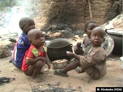 Children eating some food in Tchakarmari village, Cameroon, Apr, 20, 2019.