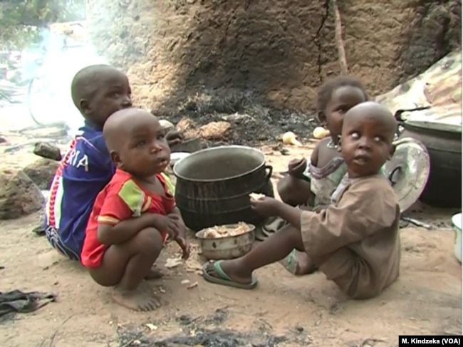 Children eating some food in Tchakarmari village, Cameroon, Apr, 20, 2019.