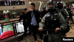 香港警察進入一家商場驅散在商場內舉行平安夜示威活動的抗議者。（2019年12月24日）