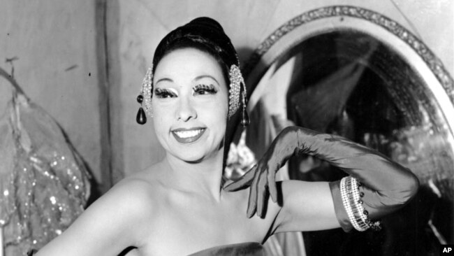 FILE - In this file photo dated March 6, 1961, singer Josephine Baker poses in her dressing room at the Strand Theater in New York City, USA. The remains of American-born singer and dancer Josephine Baker will be reinterred at the Pantheon monument in Paris.