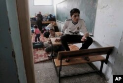 Palestinians take shelter at the United Nations school after they fled their homes in Gaza City, July 13, 2014.