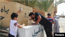 People drink water during a water shortage in Tripoli, Libya, on June 13, 2019. REUTERS/Hazem Ahmed