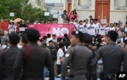 FILE - Police stand watch as anti-coup demonstrators rally to mark the second anniversary of the military takeover of government, in Bangkok, Thailand, May 22, 2016. HRW says “Thailand’s human rights crisis has worsened over the year as the military junta tightened its grip on power and led the country deeper into dictatorship.”
