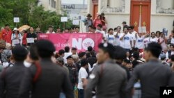 FILE - Police stand watch as anti-coup demonstrators rally to mark the second anniversary of the military takeover of government, in Bangkok, Thailand, May 22, 2016.