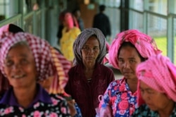 Women arrive at the entrance gate to the Extraordinary Chambers in the Courts of Cambodia (ECCC) for the trial hearing on evidences of forced marriage and rape during the Khmer Rouge regime, Phnom Penh, Cambodia, August 23, 2016. (REUTERS)