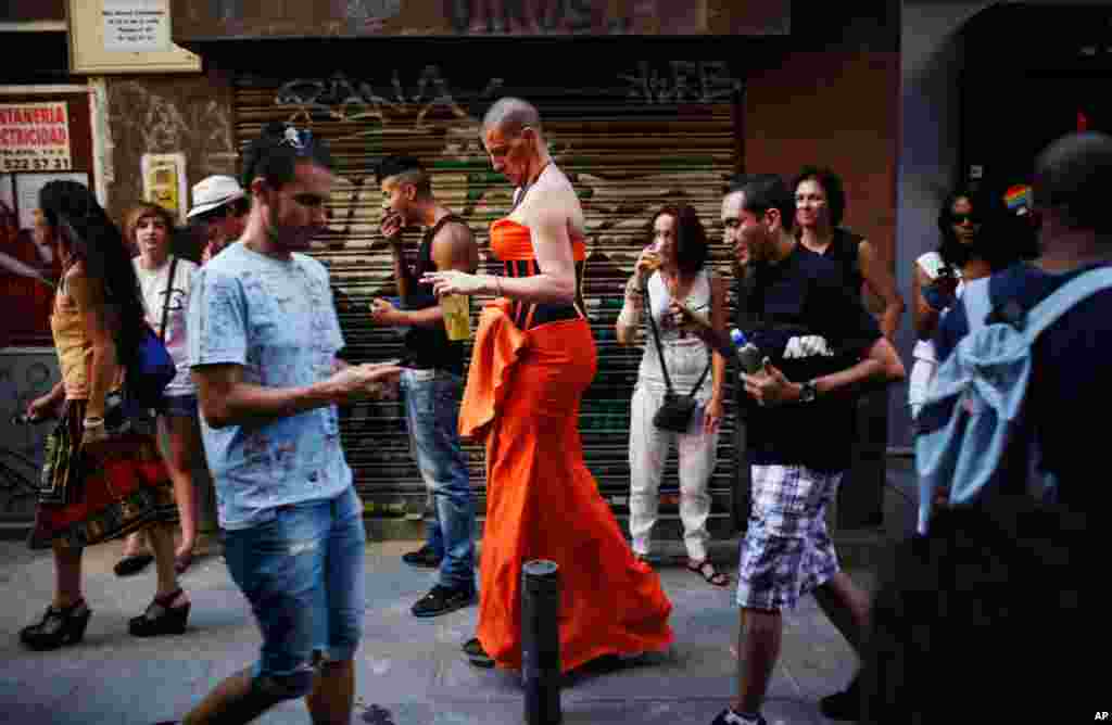 June 30: A transvestite in Madrid heads to the annual race on high heels during Gay Pride celebrations. (REUTERS/Susana Vera)