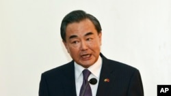 FILE - Chinese Foreign Minister Wang Yi gestures during a press conference.