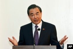 Chinese Foreign Minister Wang Yi gestures during a press conference after meeting Myanmar's new Foreign Minister Aung San Suu Kyi, leader of the National League for Democracy party (NLD), in Naypyitaw, Myanmar, April 5, 2016.