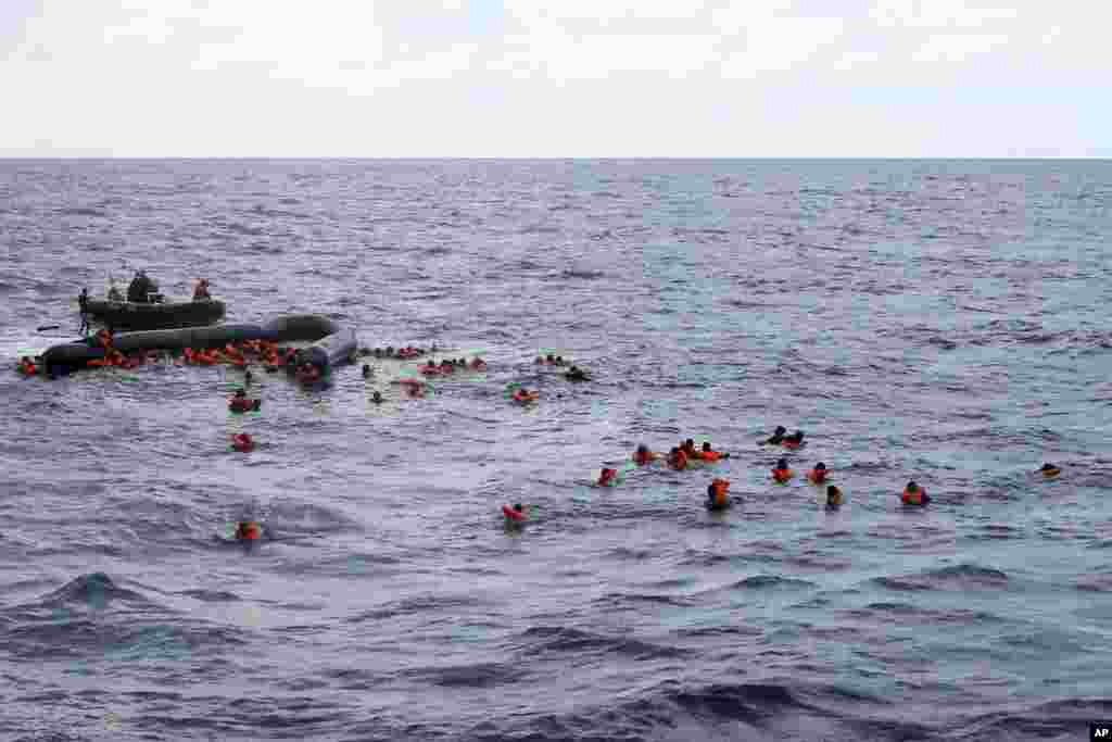 Refugees and migrants are rescued by members of the Spanish NGO Proactiva Open Arms, after leaving Libya trying to reach European soil aboard an overcrowded rubber boat in the Mediterranean sea.