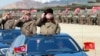 North Korean leader Kim Jong Un salutes as he arrives to inspect a military drill at an unknown location, in this undated photo released by North Korea's Korean Central News Agency, March 25, 2016.
