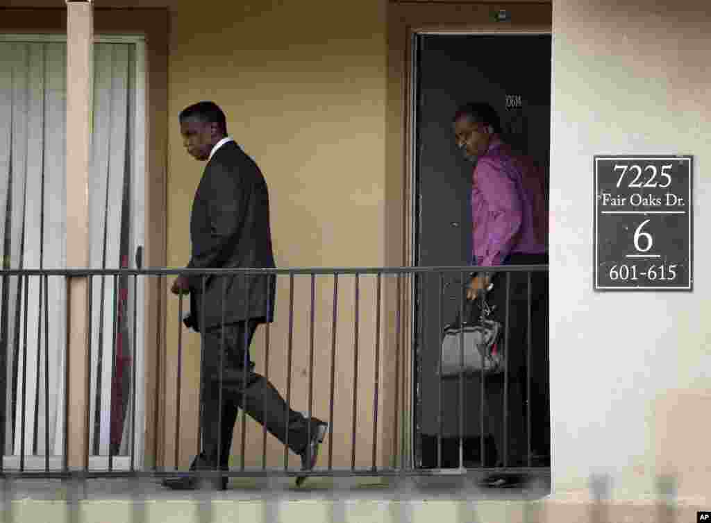 Dallas County Health and Human Services Director Zachary Thompson and Christopher Perkins, D.O., M.P.H. Medical Director / Health Authority with DCHHS walk out of an apartment unit at The Ivy Apartment Complex, Oct. 2, 2014.