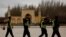 FILE - Police walk in front of the Id Kah Mosque in the old city of Kashgar, Xinjiang Uighur Autonomous Region, China, March 22, 2017.