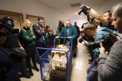 Evidence is brought to a courtroom in Pezinok, Slovakia, Thursday, Dec. 19, 2019. The trial opens on Thursday with the suspected mastermind, Marian Kocner, in the slaying of an investigative journalist Jan Kuciak and his fiancee Martina Kusnirova , who we