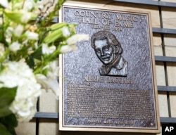 Flowers memorialize the death of Merle Haggard near his plaque in the Country Music Hall of Fame in Nashville, Tenn., April 6, 2016.