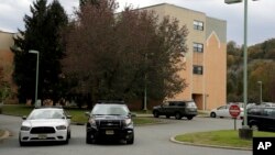 FILE - Police cruisers are parked near the entrance of the Wanaque Center for Nursing And Rehabilitation in Haskell, N.J., where New Jersey health officials have confirmed 28 cases of adenovirus as of Nov. 1, 2018. 