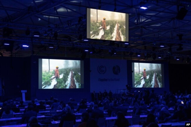 A climate change video plays during the opening session of the COP26 U.N. Climate Summit, Nov. 1, 2021, in Glasgow, Scotland.