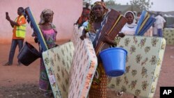 Civilians who fled their homes following an attack by Islamist militants, in North East Nigeria walk away after receiving relief materials from the government at the camp for internally displaced people in Yola, Nigeria, Jan. 27, 2015.