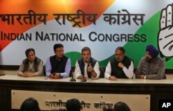 Congress Party leader Rahul Gandhi, center, holds a press conference as results are counted in five states that recently went to the polls, in New Delhi, India, Dec. 11, 2018.