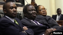 Zimbabwe Vice President Joice Mujuru (R), Prime Minister Morgan Tsvangirai (C) and member of the House of Assembly of Zimbabwe for Kuwadzana, Nelson Chamisa, attend the presentation of the Final Draft of the Constitution for debate in Parliament Building. 