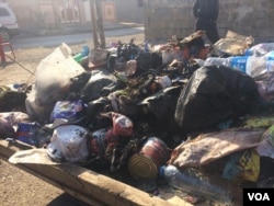 In the relative safety of Mosul neighborhoods where IS fled weeks or months ago, trash piles build up and locals say their immediate concern is now health issues from the increasing pollution, Jan. 9, 2017. (H. Murdock/VOA)