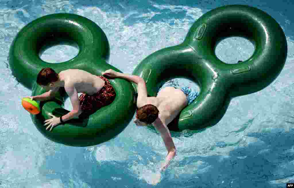 Two men play in the Duinrell amusement park in Wassenaar as Europe sizzled in a continent-wide heatwave.