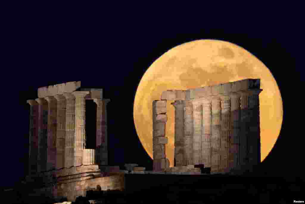 The full moon, known as the &quot;Super Flower Moon&quot; rises over the Temple of Poseidon in Cape Sounion, near Athens, Greece, May 26, 2021.