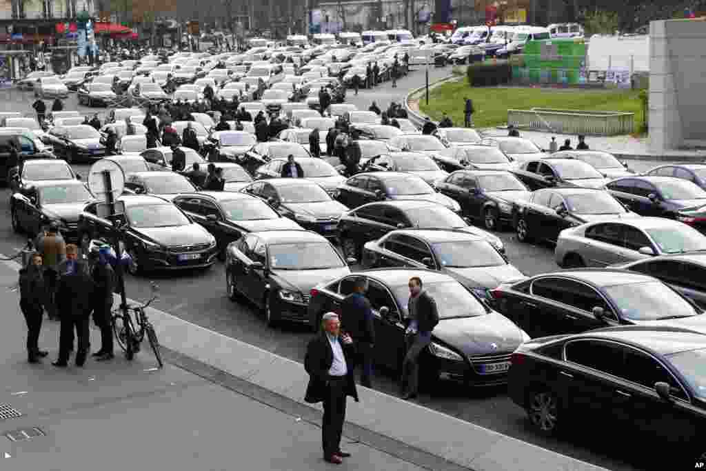 French livery drivers block traffic during &quot;Snail Operation&quot; at Port Maillot, one of the entries to Paris. Drivers are protesting a drop in their rates, striking out again, against what they say is unfair competition by Uber and other companies.