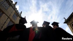 FILE - A group of graduates have their photograph taken after a graduation ceremony at Oxford University, Oxford, England, May 28, 2011. Thirty-two U.S. students will enroll at the prestigious school in the fall of 2017 as Rhodes scholars. Ninety-five scholars will be selected worldwide this year.