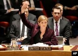 FILE - U.S. Ambassador to the United Nations Samantha Power votes on a resolution during a Security Council meeting at U.N. headquarters in New York, March 2, 2016.