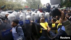 Demonstrators are stopped by the police during a protest against Saturday's bombings that took place in Ankara, in Istanbul, Turkey, Oct. 13, 2015. 