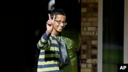 Ahmed Mohamed, 14, gestures as he arrives to his family's home in Irving, Texas, Sept. 17, 2015.