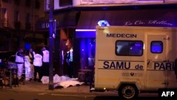 Medical staff stand by victims in a Paris restaurant, Nov. 13, 2015.