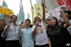 Pro-democracy Hong Kong lawmakers of the legislature council, Edward Yiu, Nathan Law, Leung Kwok-hung and Lau Siu-lai protest outside the High Court in Hong Kong, July 14, 2017.